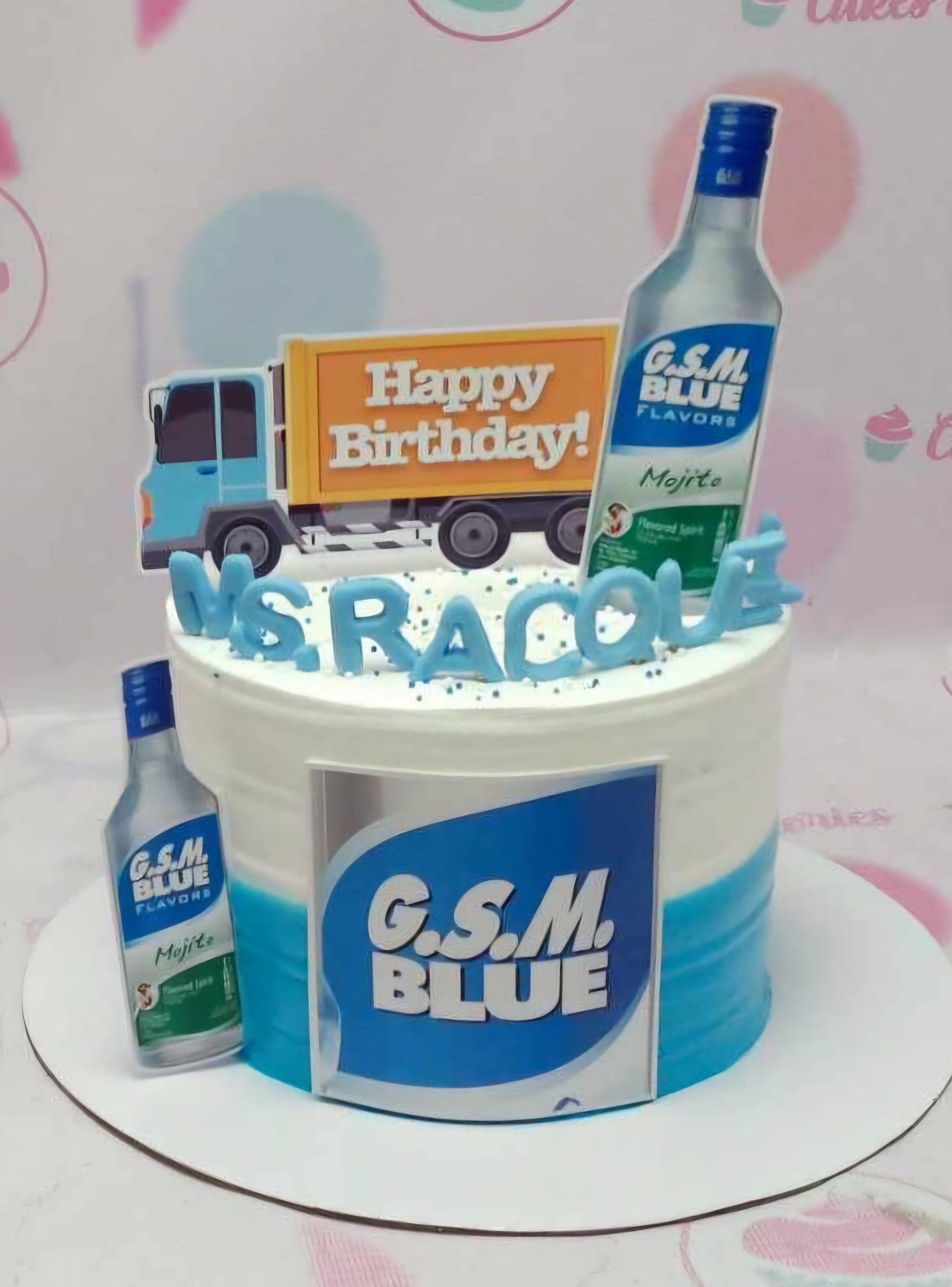 This custom drinks cake features a stunning white and blue design, adorned with a Ginebra San Miguel bottle and mojito-themed decor. The cake is topped with "Happy Birthday Sir" printout toppers, making it perfect for a relaxed celebration.