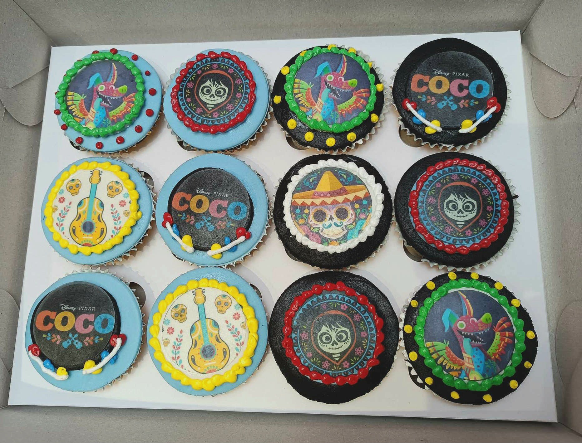 This custom Coco Cupcakes cake features a beautifully crafted fondant Miguel with his guitar, capturing the essence of the Day of the Dead celebration. Perfect for music lovers, this one-tier cake is adorned with colorful details that pay homage to Pixar's beloved film.