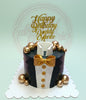 Custom birthday cake featuring a black suit, white shirt, and gold bow tie design with 'Happy Birthday Daddy Marto' topper.