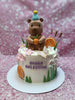 One-tier Capybara Birthday Cake with a brown capybara topper, pink flowers, orange slices, and 'NIKKA CELESTINE' on cream icing.