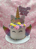 One-tier unicorn birthday cake with white buttercream, rainbow wings, pastel flowers, gold horn, and 'Happy 5th Birthday ALFEE' topper.