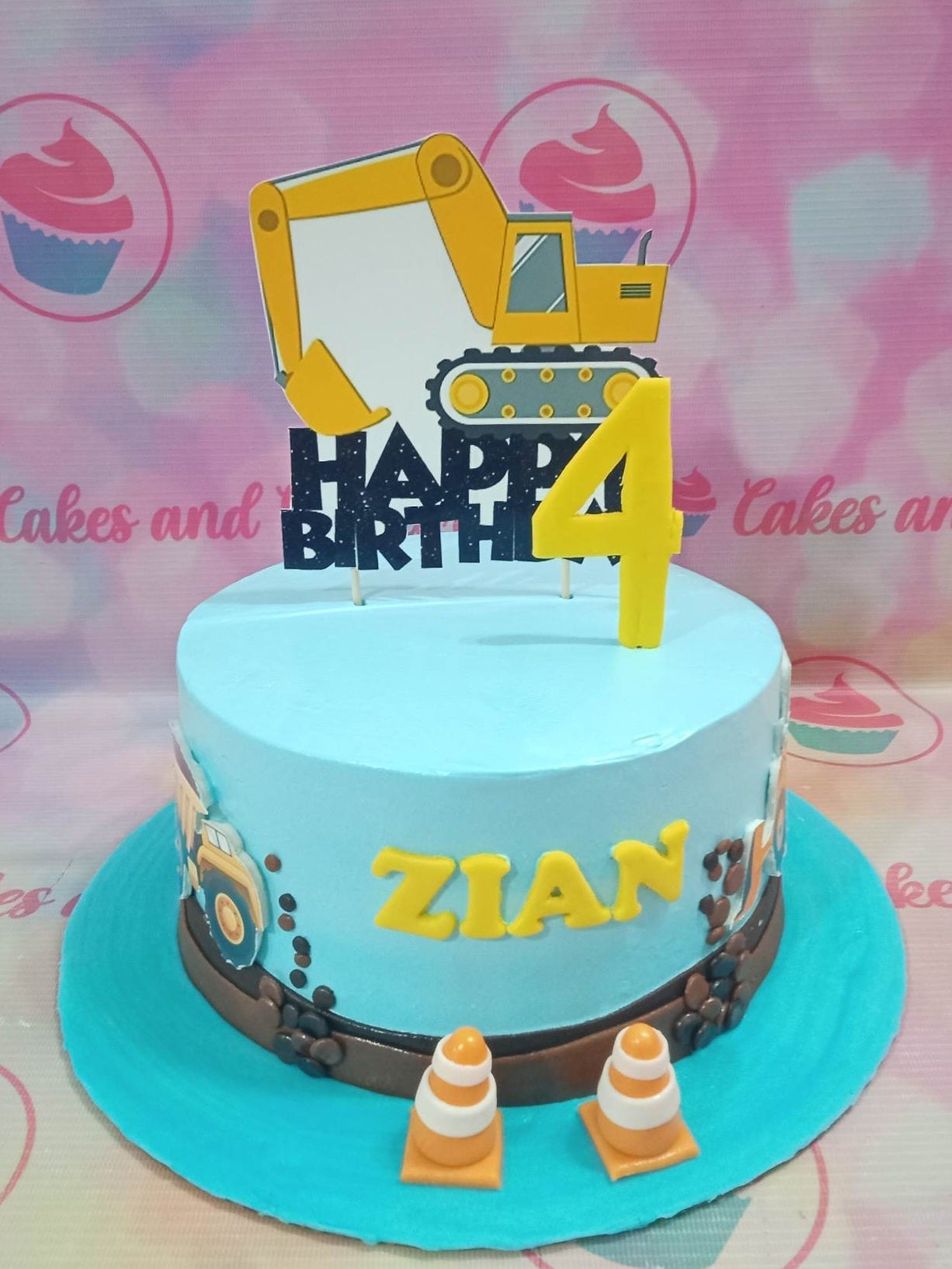 This Construction Cake is perfect for the young builder-to-be in your life. Featuring an Excavator and Backhoe on the outside and little buildable toys inside, this Customized Cake is sure to be a hit at their Birthday party. Made with the highest quality, your little one will love this truck-themed cake!