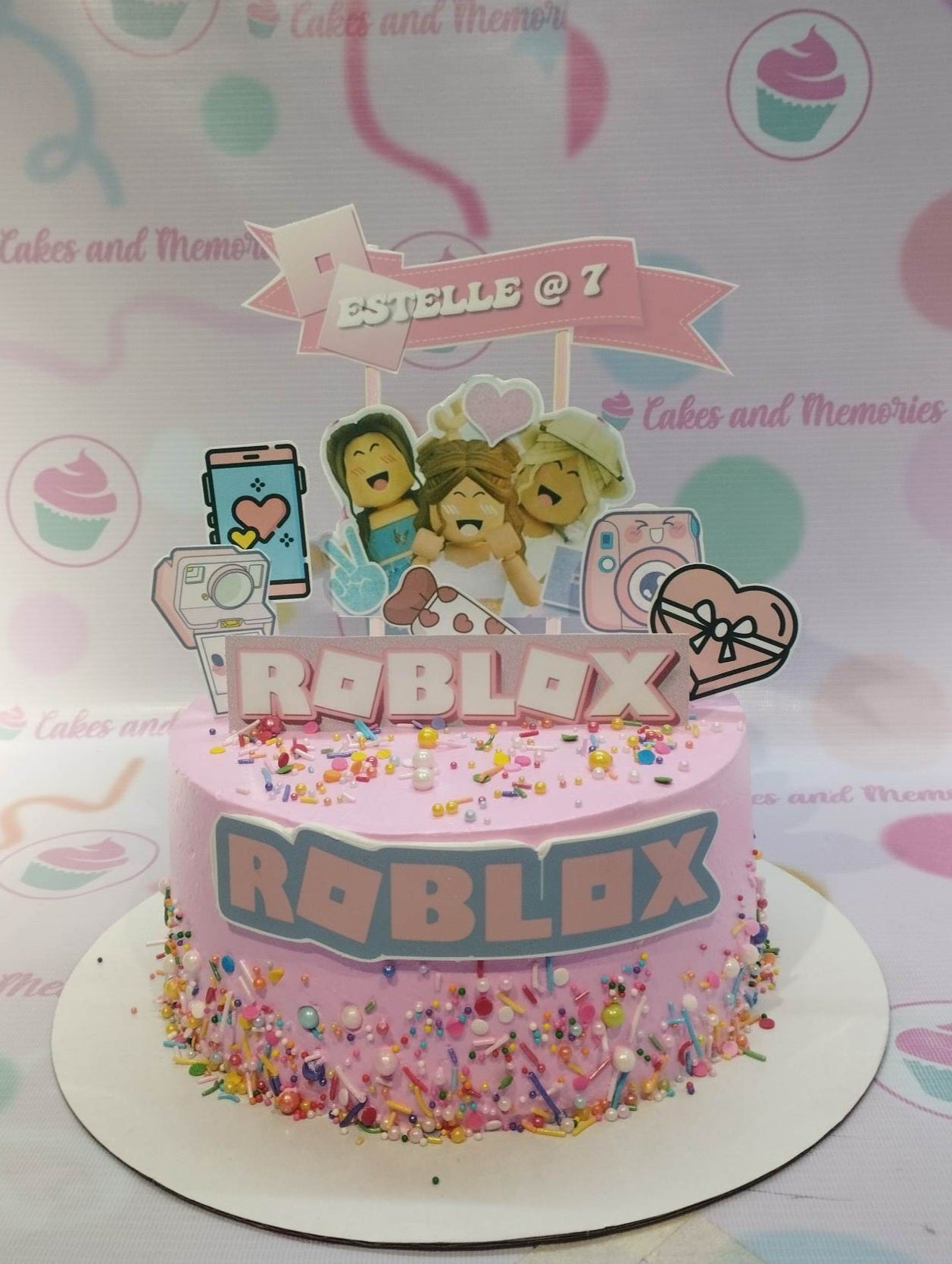 This custom decorated cake is perfect for any party or special occasion. It features Roblox game blocks and figures in vibrant pink, purple and blue colors, with a generous helping of sprinkles. It's perfect for a kid's or boy's birthday and is sure to impress with its quality and attention to detail.