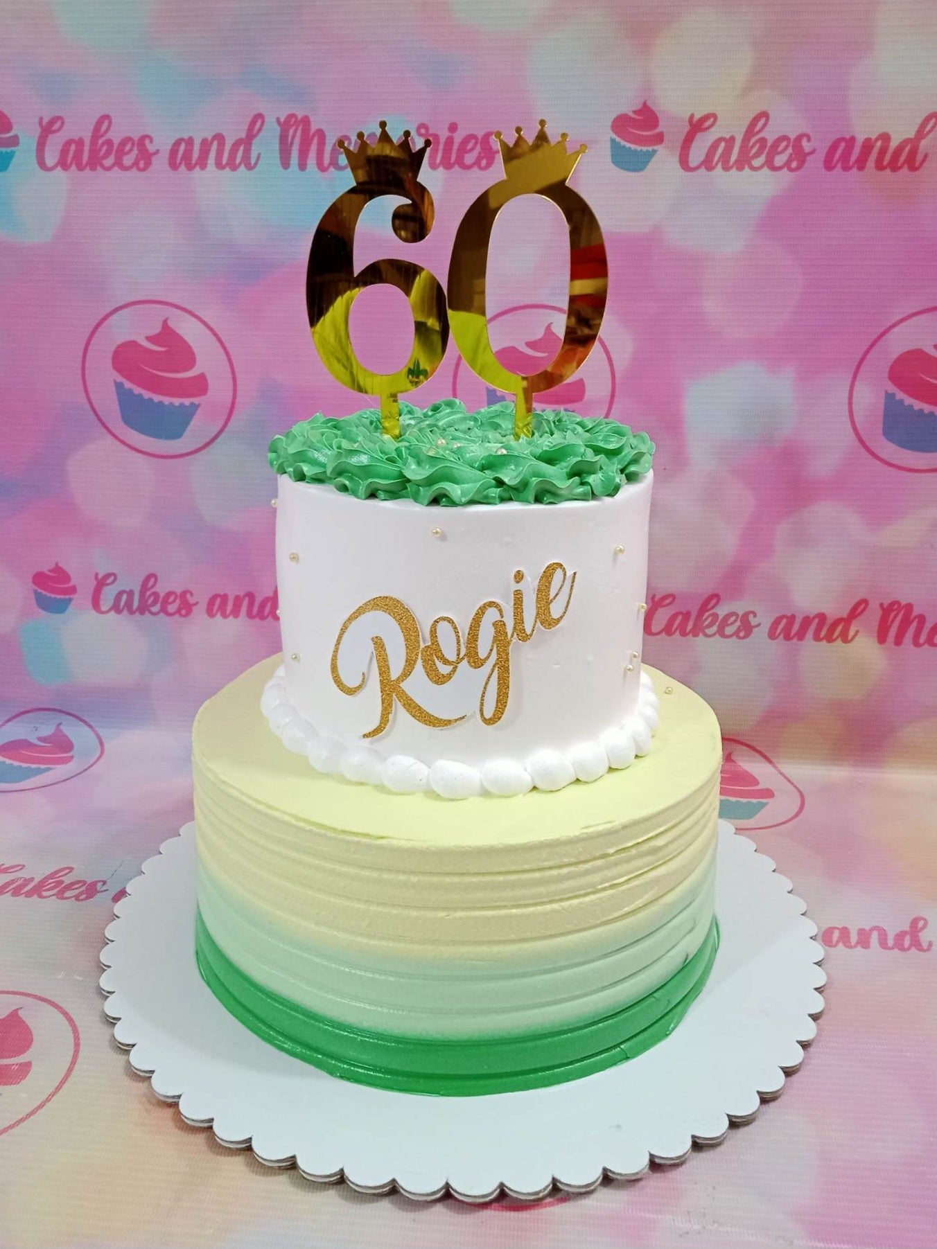 This stunning Fifty Cake is the perfect way to celebrate a milestone birthday. Featuring an ombre design in shades of green and gold, it's finished with a custom topper for a special grandmother or grandfather. Celebrate fifty and sixty in style with this beautiful customized cake!