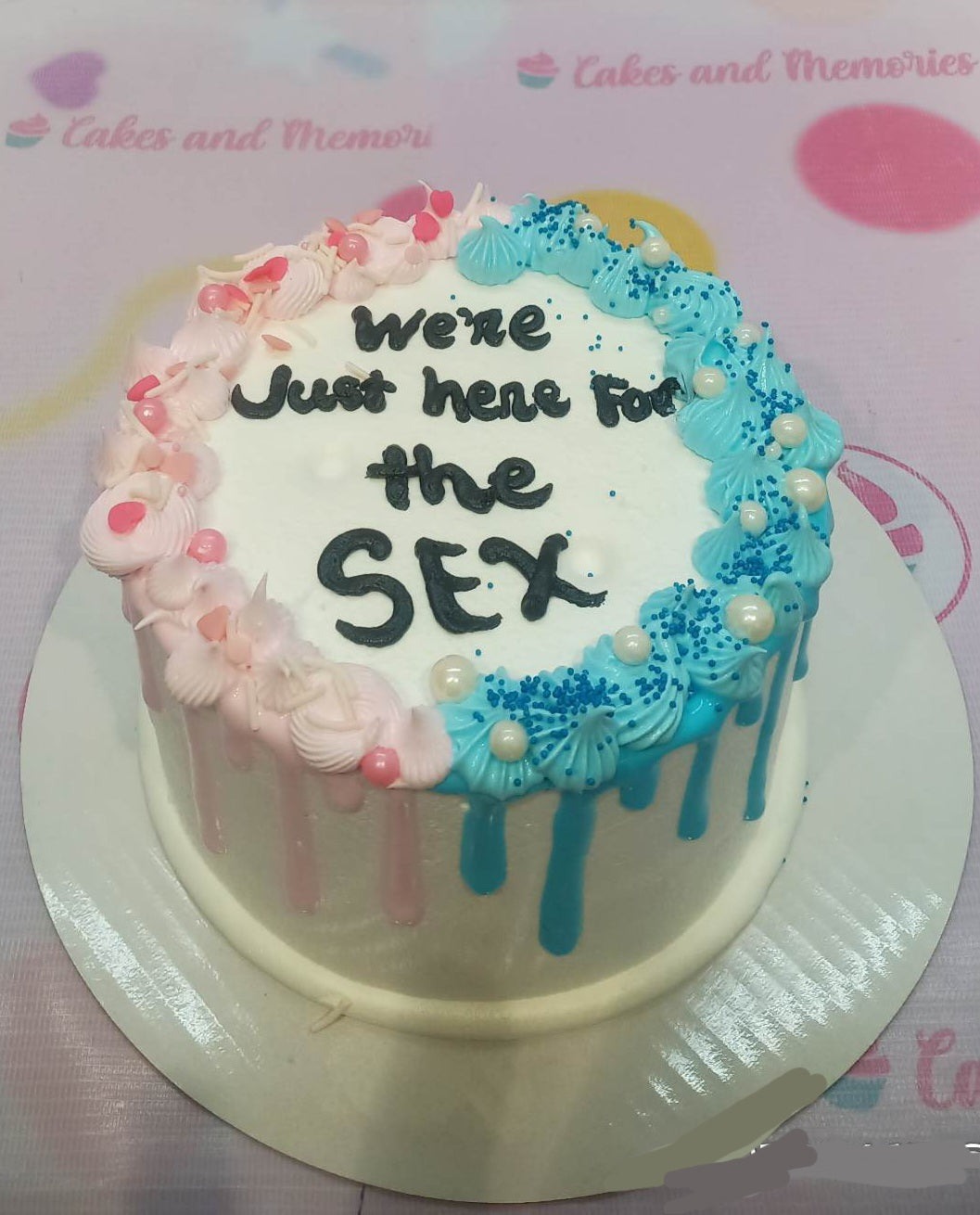 This gorgeous Gender Reveal Cake is the perfect way to announce the gender of your baby. It has a beautiful combination of pink and blue colors, with a phrase - "We're Just Here for the Sex" - adorning the cake. The cake is customizable, with options to include a baby and other elements related to gender reveal or pregnancy. It is perfect for celebrating the upcoming arrival of a baby boy or girl!