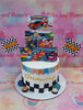 .

This custom decorated cake features an exciting racing checkered flag design and features Jolibee with his friends Hetty and other Fastfood Pinoy characters. The cake is white with vibrant colors, perfect for a birthday celebration. All decorations are of excellent quality.