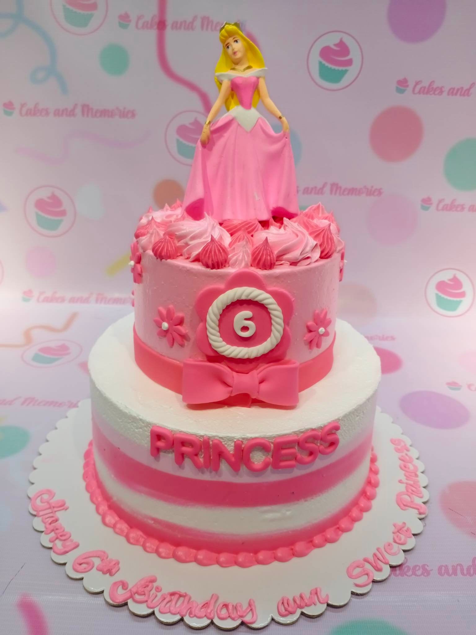 This Aurora Cake is a perfect way to add a touch of enchantment to your special event. It is decorated with bright pink stripes and featuring Sleeping Beauty and Disney Princess designs, making it a perfect treat for any princess-themed celebration. Crafted with great attention to detail, this cake is sure to bring a little magic to your day!