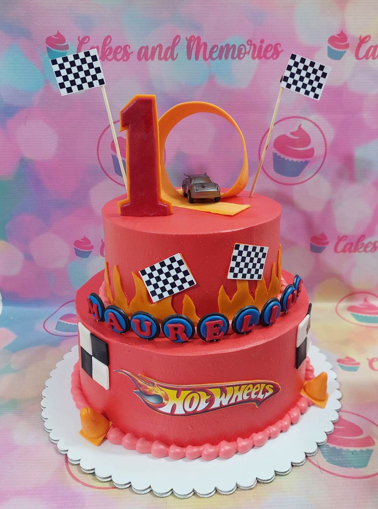 This Hotwheels Cake is perfect for your children's next birthday party! It includes a red race car toy decoration making it a fun and unique custom cake. With its high quality construction, this cake will be a hit with kids and adults alike.