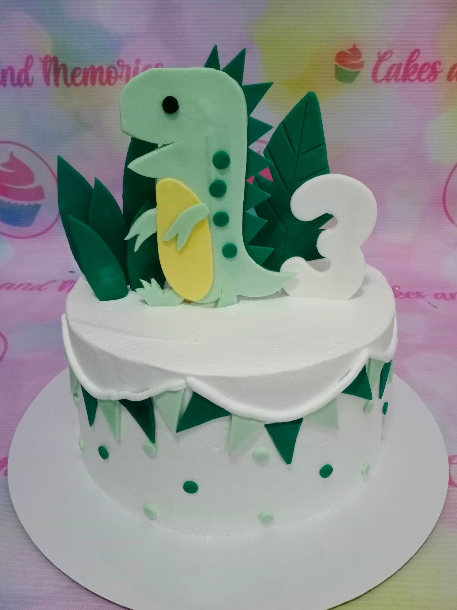 This Dinosaurs Cake customized for children's birthday is perfectly designed to entertain all guests. With white base and detailed green dino decorations, it is sure to bring the Jurassic Park and Jurassic World experience to life. Every detail of this dino cake is made with superior quality for a custom birthday cake.