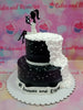 This custom decorated cake is perfect for a women's special 18th birthday. It is decorated in black and white rosettes for a timeless and classic look to commemorate the debutante. Made with the highest quality materials and craftsmanship, this cake is sure to be a hit at the celebration.