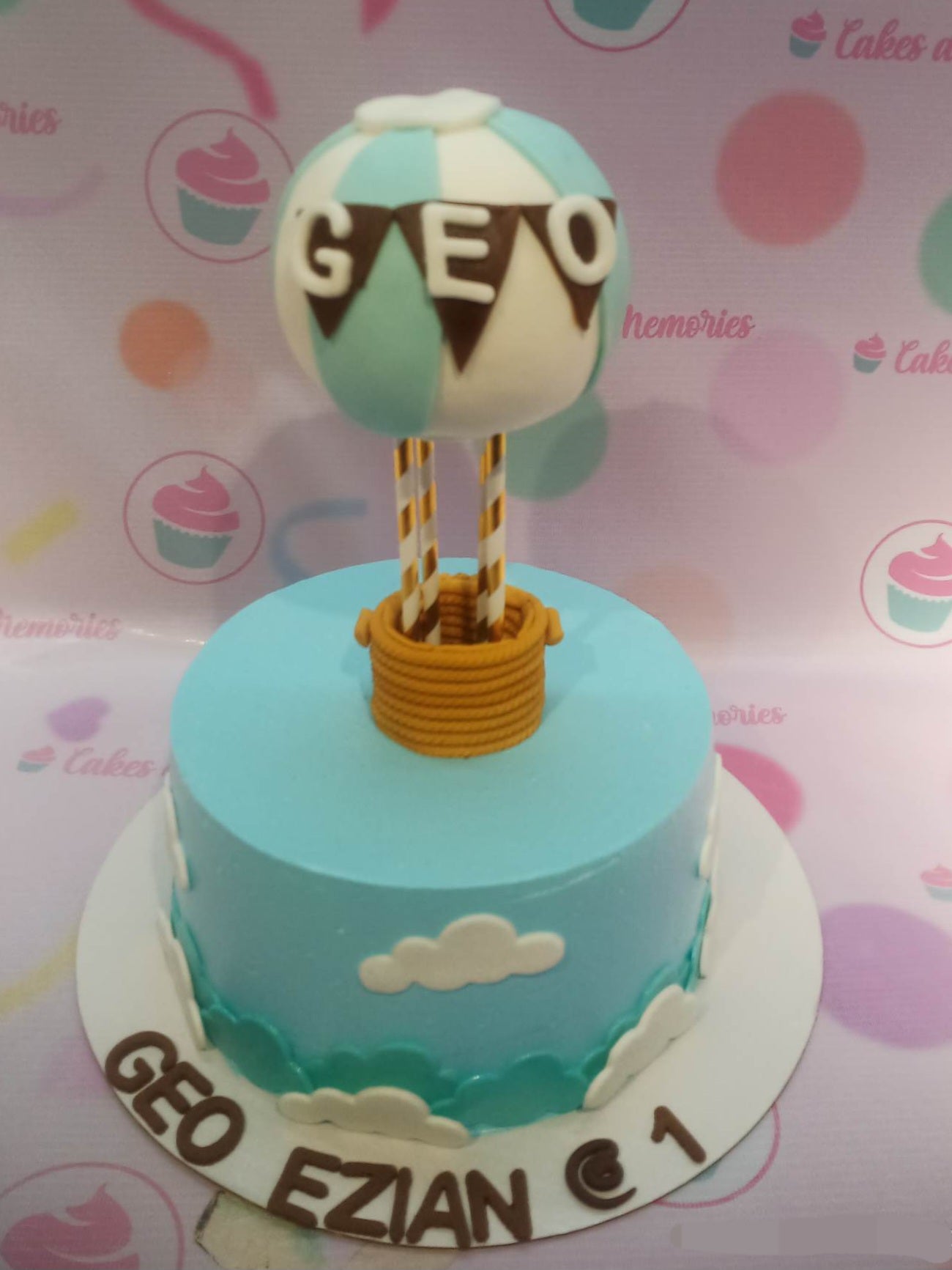 This Hot Air Balloon Cake is the perfect way to celebrate a special occasion! Decorated in shades of blue, white, and sky, with clouds and dolls in hot pink and purple, this is a beautiful and unique cake. Perfect for baptisms, birthday parties, and christenings, this customized hot air balloon cake will be the standout of the event!